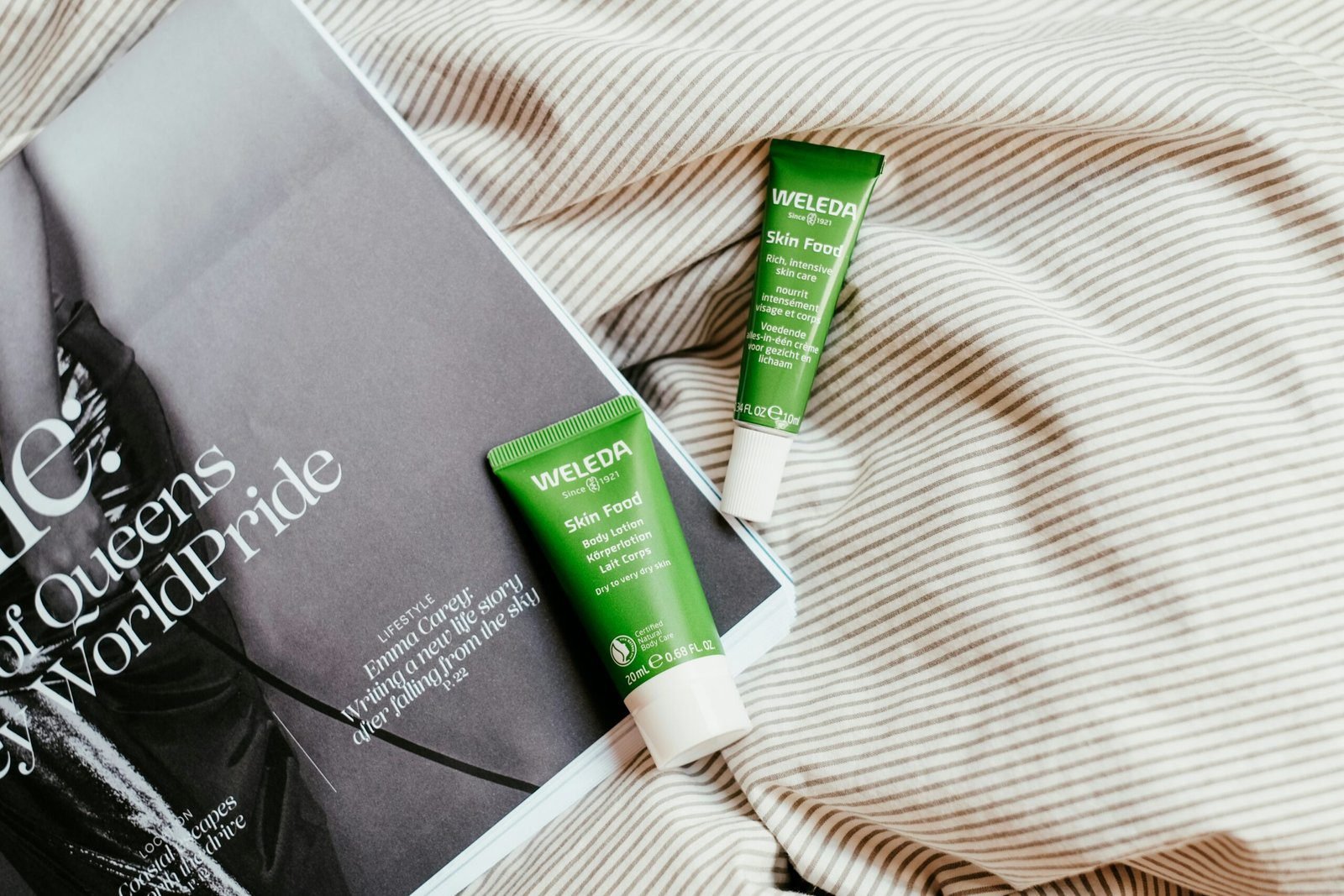 a couple of tubes of toothpaste sitting on top of a bed